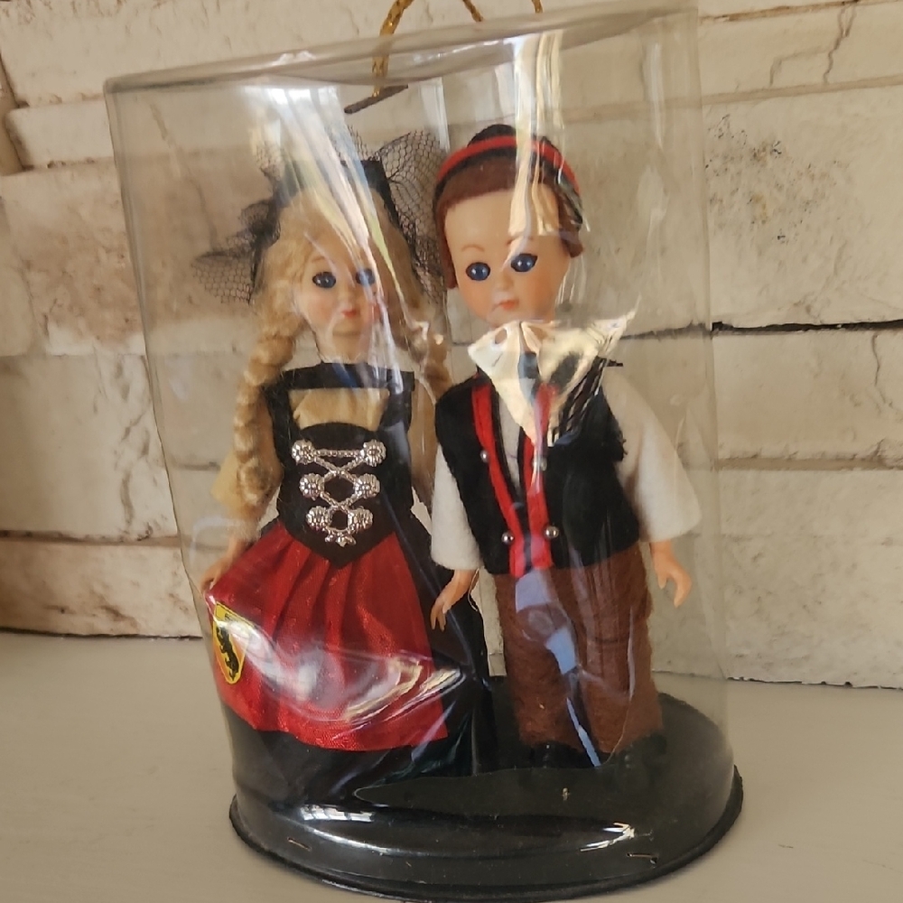 Set of 2 German Dolls in Plastic Display Dome - Red, Black, Brown